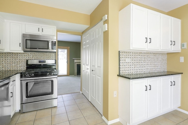 736 73rd St Unit 0, Downers Grove, IL 60516 - kitchen with appliances with stainless steel finishes, white cabinets, and dark stone counters