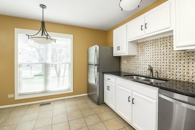 736 73rd St Unit 0, Downers Grove, IL 60516 - kitchen with appliances with stainless steel finishes, backsplash, healthy amount of natural light, and dark stone countertops