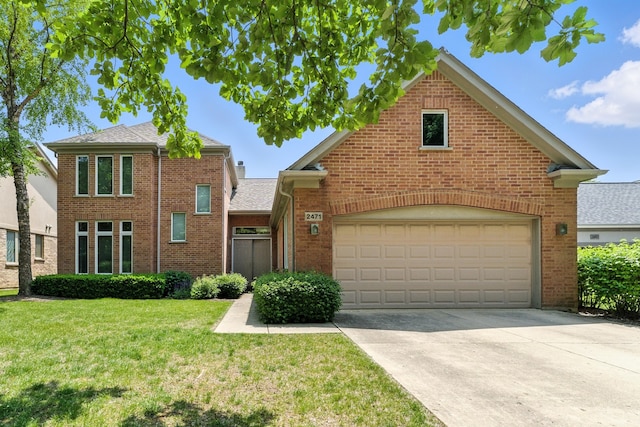 2471 Augusta Way, Highland Park, IL 60035 - traditional home with brick siding, a front lawn, concrete driveway, a garage, and roof with shingles