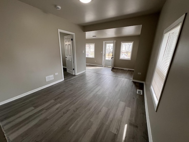 920 S Mcalister Ave, Waukegan, IL 60085 - unfurnished living room featuring dark wood-style floors and baseboards