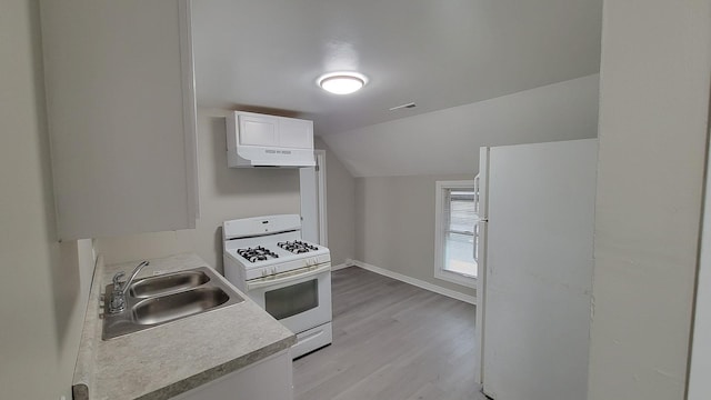 920 S Mcalister Ave, Waukegan, IL 60085 - kitchen with white appliances, under cabinet range hood, vaulted ceiling, light wood-style floors, and white cabinets