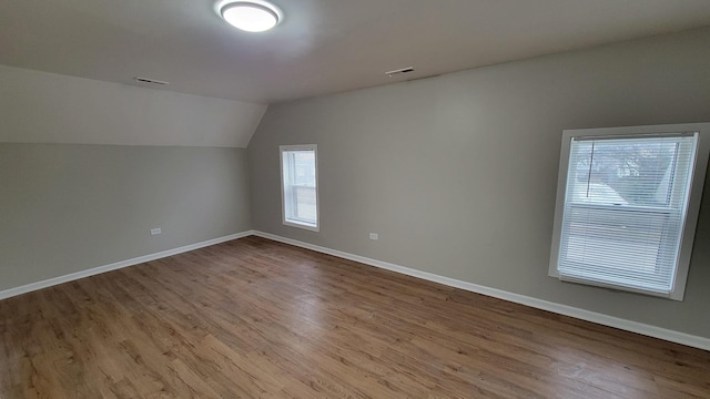 920 S Mcalister Ave, Waukegan, IL 60085 - additional living space featuring healthy amount of natural light, wood finished floors, and vaulted ceiling