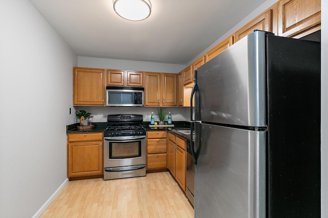 263 S Clubhouse Dr Unit 126, Palatine, IL 60074 - kitchen with stainless steel appliances, light wood finished floors, dark countertops, and brown cabinets