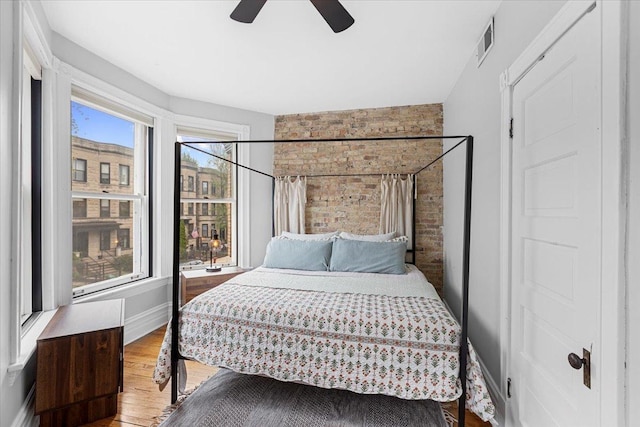 3828 N Wilton Ave, Chicago, IL 60613 - bedroom with wood finished floors, baseboards, and ceiling fan