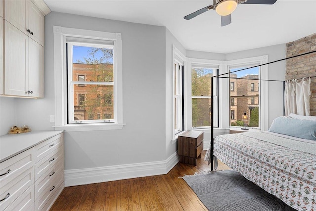 3828 N Wilton Ave, Chicago, IL 60613 - bedroom with baseboards, wood-type flooring, multiple windows, and ceiling fan