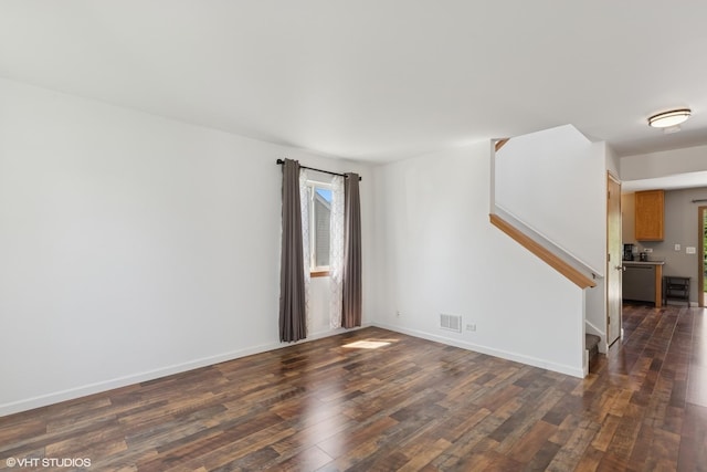 261 E Camden Ln, Round Lake Beach, IL 60073 - empty room featuring dark wood finished floors, stairs, and baseboards