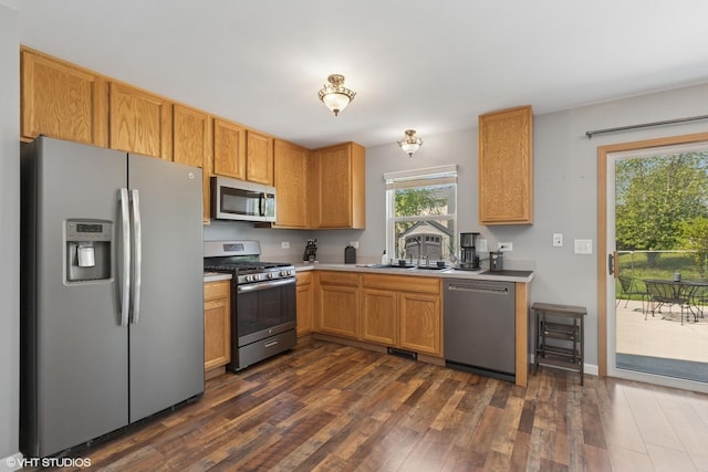 261 E Camden Ln, Round Lake Beach, IL 60073 - kitchen with stainless steel appliances, a sink, dark wood-style floors, and light countertops