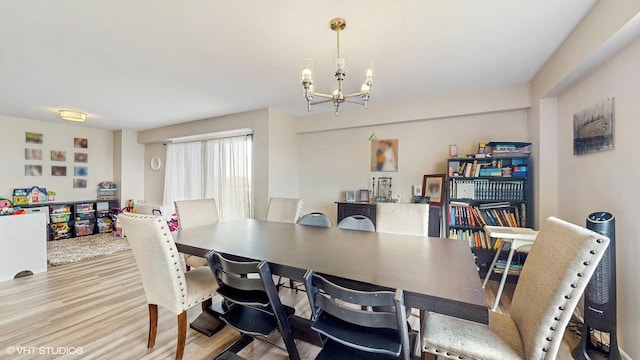 6833 N Kedzie Ave Unit 716, Chicago, IL 60645 - dining space featuring wood finished floors and a chandelier