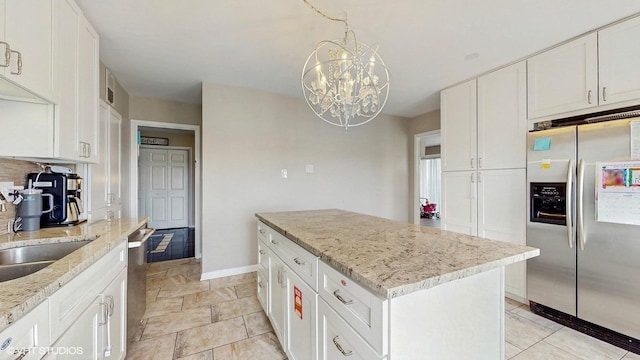 6833 N Kedzie Ave Unit 716, Chicago, IL 60645 - kitchen with appliances with stainless steel finishes, a chandelier, white cabinets, a center island, and light stone counters