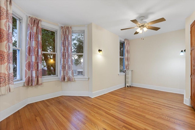 3357 S Oakley Ave, Chicago, IL 60608 - unfurnished room featuring light wood-type flooring, baseboards, and a ceiling fan