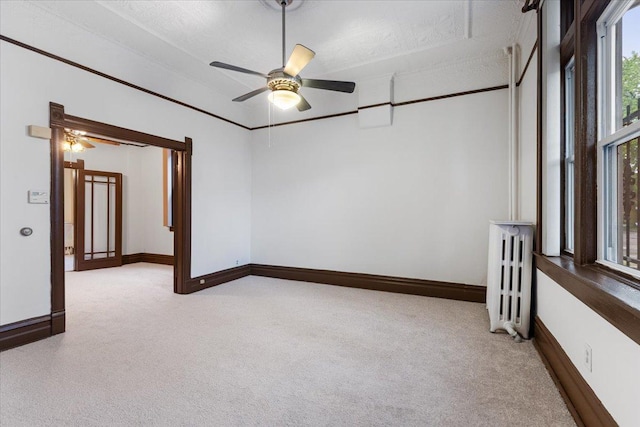 3357 S Oakley Ave, Chicago, IL 60608 - empty room with radiator heating unit, light carpet, ceiling fan, and baseboards