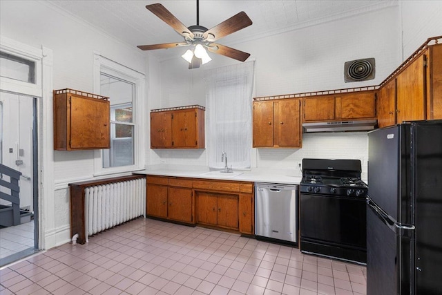3357 S Oakley Ave, Chicago, IL 60608 - kitchen with black appliances, radiator, a sink, under cabinet range hood, and brown cabinetry