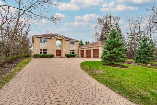 view of front of home with decorative driveway and a front lawn