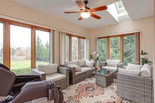 living room with ceiling fan, a skylight, and plenty of natural light