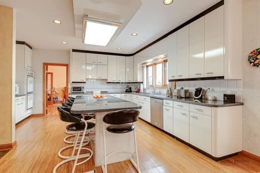 kitchen with dishwasher, light wood finished floors, a breakfast bar area, a kitchen island, and recessed lighting
