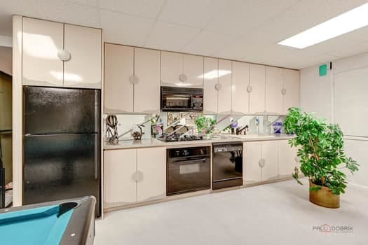 kitchen featuring black appliances, light countertops, white cabinets, and billiards table