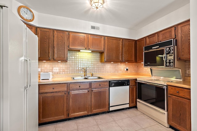 9900 Shady Ln Unit 3Ne, Orland Park, IL 60462 - kitchen with white appliances, light countertops, tasteful backsplash, and brown cabinetry