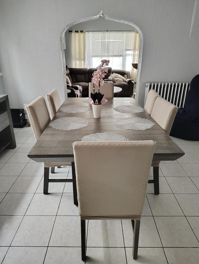 2240 W 50th Pl, Chicago, IL 60609 - dining room featuring tile patterned floors, arched walkways, and a textured wall