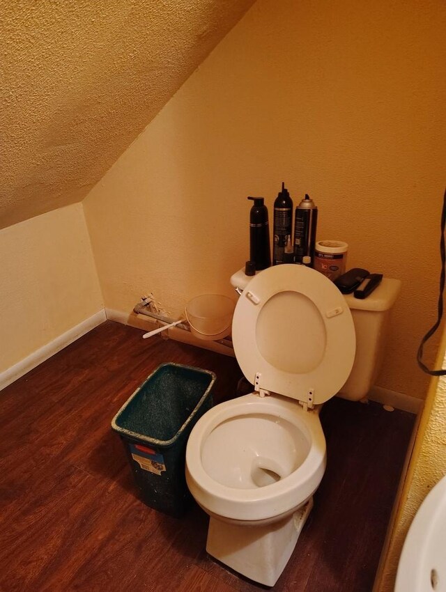 2240 W 50th Pl, Chicago, IL 60609 - bathroom with a textured ceiling, wood finished floors, toilet, lofted ceiling, and baseboards