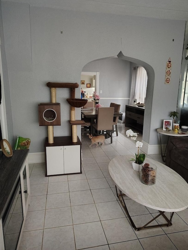 2240 W 50th Pl, Chicago, IL 60609 - dining space featuring arched walkways, light tile patterned floors, and baseboards