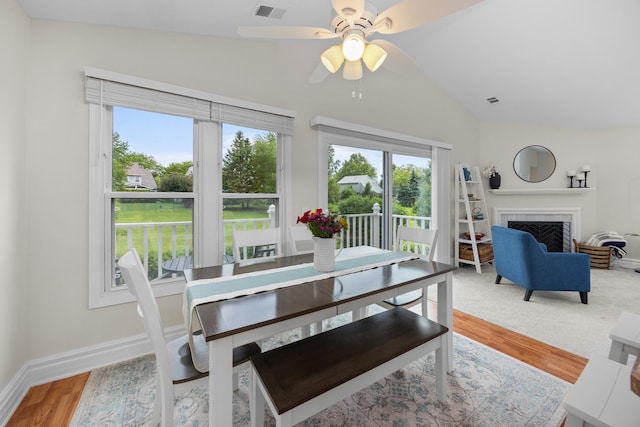 1795 Vermont Dr Unit A, Elk Grove Village, IL 60007 - dining room featuring lofted ceiling, wood finished floors, ceiling fan, and a tiled fireplace