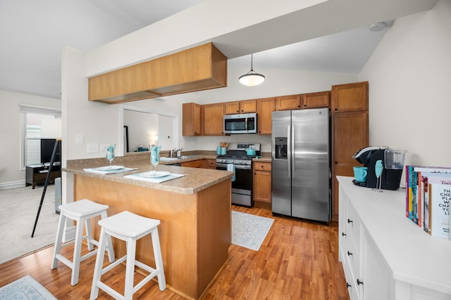 1795 Vermont Dr Unit A, Elk Grove Village, IL 60007 - kitchen with appliances with stainless steel finishes, brown cabinets, a peninsula, and lofted ceiling