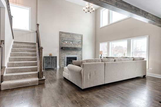26101 W Forrester Dr, Plainfield, IL 60585 - living area featuring a chandelier, stairs, a fireplace, dark wood finished floors, and beamed ceiling