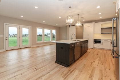 26101 W Forrester Dr, Plainfield, IL 60585 - kitchen with light wood finished floors, stainless steel appliances, a sink, light countertops, and recessed lighting