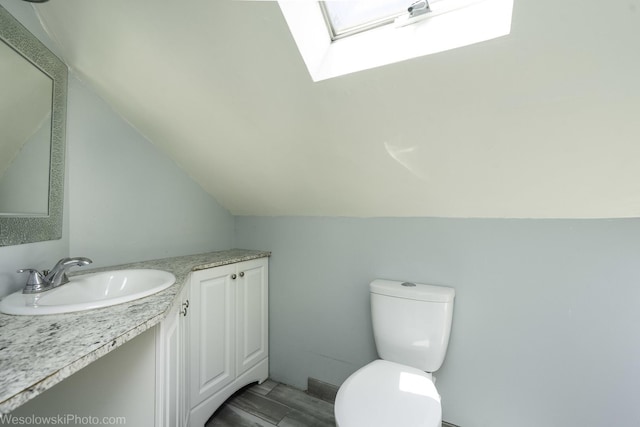 4024 N Overhill Ave, Norridge, IL 60706 - half bath featuring vanity, a skylight, and vaulted ceiling