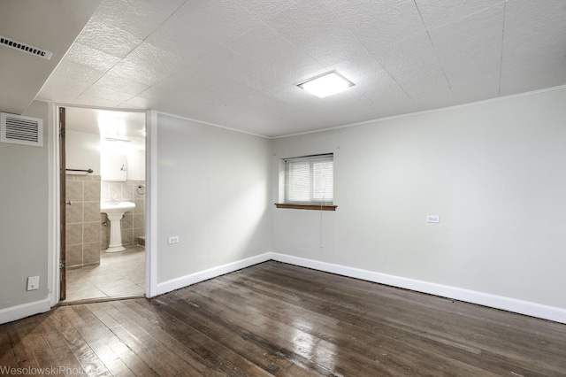 4024 N Overhill Ave, Norridge, IL 60706 - unfurnished bedroom featuring hardwood / wood-style floors, connected bathroom, tile walls, and crown molding
