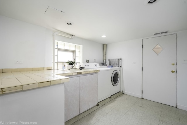 4024 N Overhill Ave, Norridge, IL 60706 - laundry room with washer and clothes dryer, light floors, and cabinet space