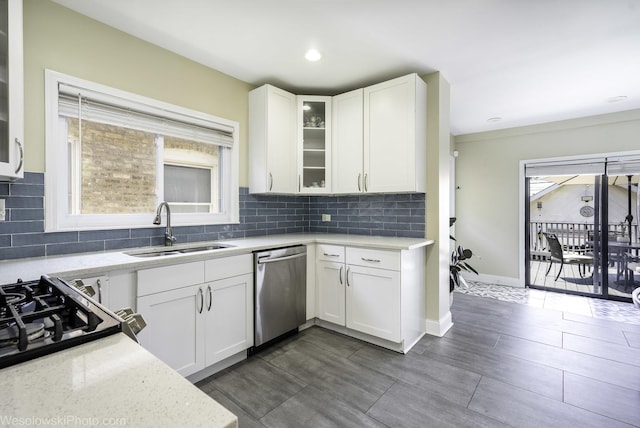 4024 N Overhill Ave, Norridge, IL 60706 - kitchen with stainless steel dishwasher, white cabinets, decorative backsplash, healthy amount of natural light, and recessed lighting
