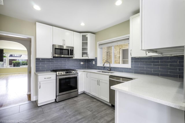4024 N Overhill Ave, Norridge, IL 60706 - kitchen with stainless steel appliances, white cabinetry, glass insert cabinets, and recessed lighting