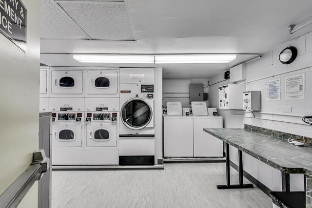 21 W Goethe St Unit 18D, Chicago, IL 60610 - community laundry with stacked washing machine and dryer, separate washer and dryer, and wood finished floors