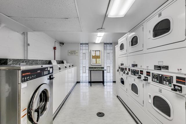 21 W Goethe St Unit 18D, Chicago, IL 60610 - communal laundry room with stacked washing machine and dryer and washer and dryer