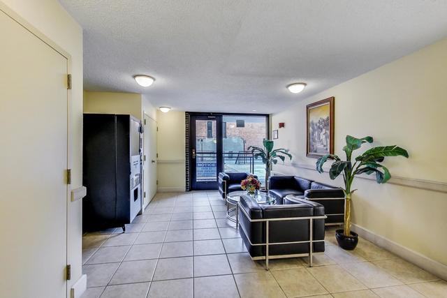 21 W Goethe St Unit 18D, Chicago, IL 60610 - living area with expansive windows, light tile patterned floors, and a textured ceiling