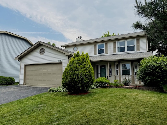 1742 Victor Ter, Gurnee, IL 60031 - traditional-style house featuring driveway, a porch, an attached garage, a front yard, and a chimney