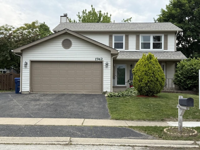 1742 Victor Ter, Gurnee, IL 60031 - traditional-style house featuring asphalt driveway, a garage, a chimney, and roof with shingles