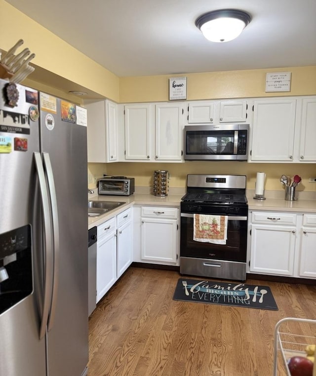 1742 Victor Ter, Gurnee, IL 60031 - kitchen featuring appliances with stainless steel finishes, light countertops, white cabinets, dark wood-type flooring, and a sink