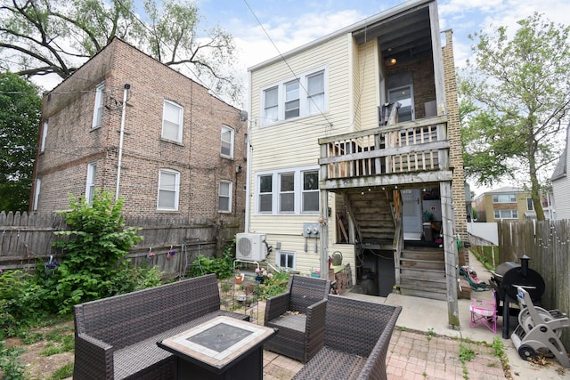 back of house featuring a fenced backyard and outdoor lounge area