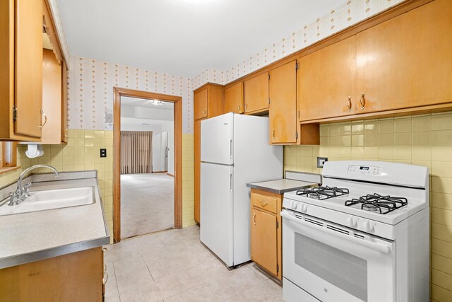 5129 N Normandy Ave, Chicago, IL 60656 - kitchen featuring white appliances, wallpapered walls, light tile patterned floors, tile walls, and brown cabinets