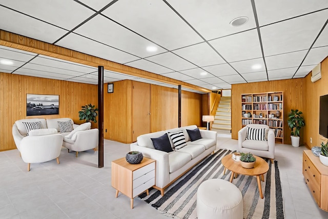 5129 N Normandy Ave, Chicago, IL 60656 - living room featuring wood walls, stairway, light tile patterned flooring, and a paneled ceiling