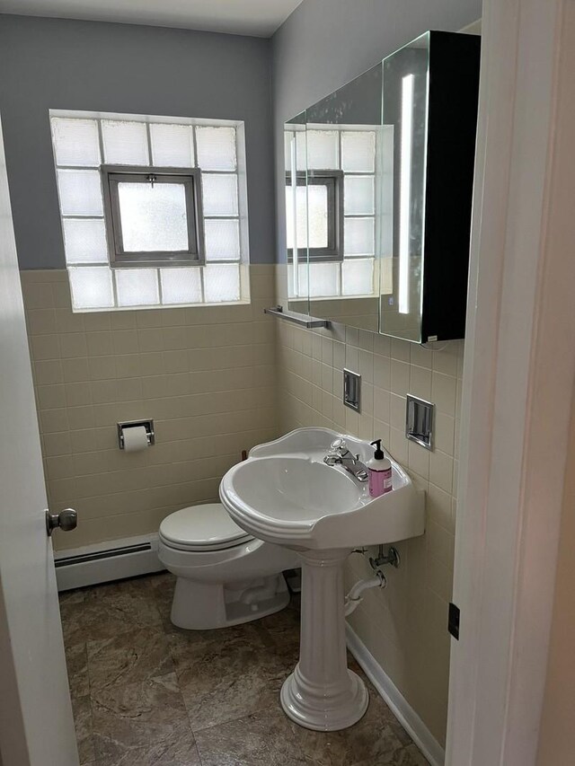 1018 E Oak Ave, La Grange Park, IL 60526 - half bathroom featuring a baseboard radiator, tile walls, and toilet