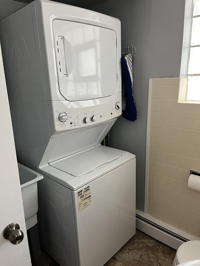 1018 E Oak Ave, La Grange Park, IL 60526 - laundry room featuring stacked washer and clothes dryer and a baseboard heating unit