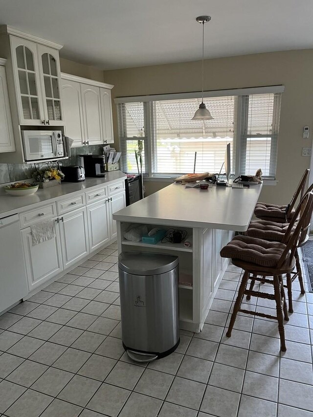 1018 E Oak Ave, La Grange Park, IL 60526 - kitchen featuring light tile patterned floors, white appliances, plenty of natural light, and glass insert cabinets