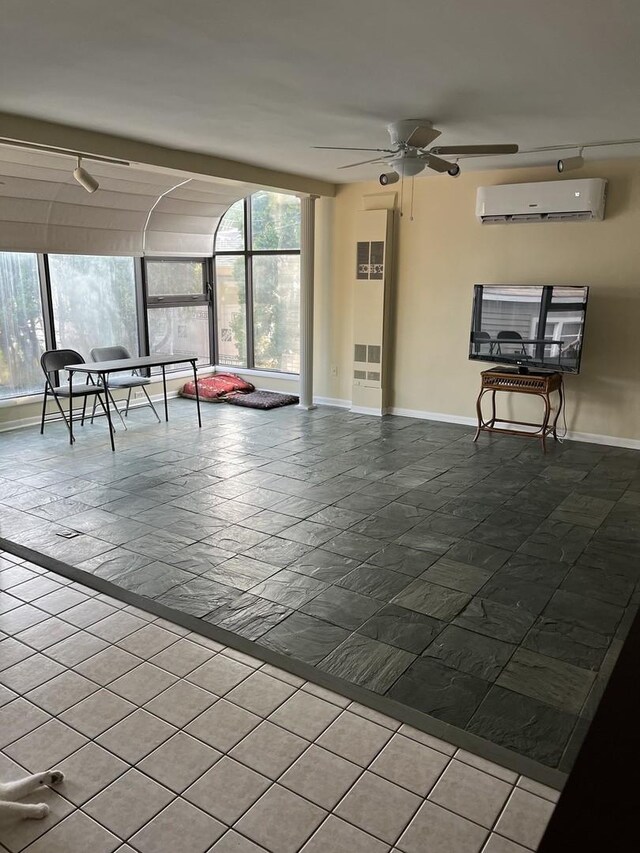 1018 E Oak Ave, La Grange Park, IL 60526 - unfurnished living room with a wall unit AC, plenty of natural light, ceiling fan, and baseboards