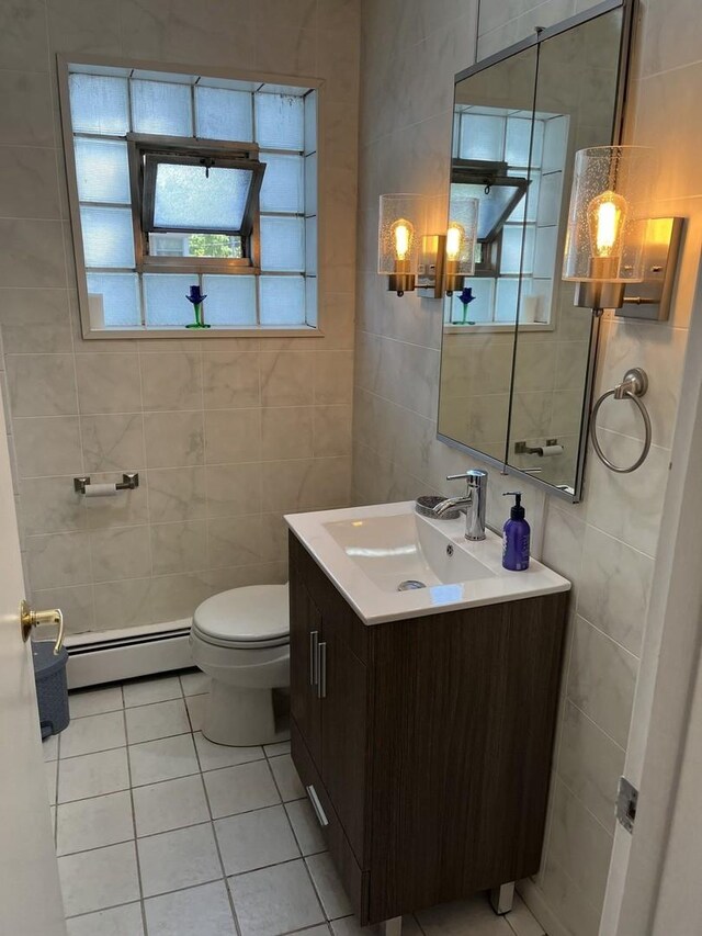 1018 E Oak Ave, La Grange Park, IL 60526 - half bathroom featuring a baseboard radiator, tile walls, tile patterned floors, vanity, and toilet