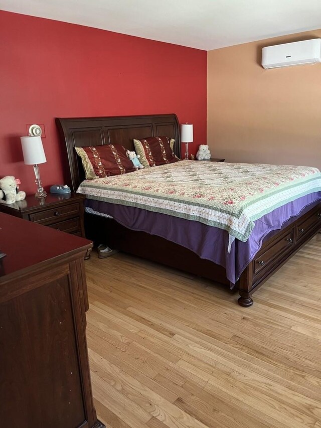 1018 E Oak Ave, La Grange Park, IL 60526 - bedroom with a wall mounted AC and light wood-style floors