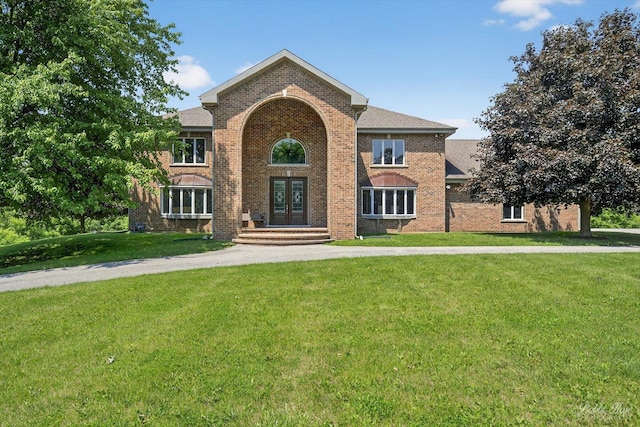 1714 Il Route 173, Spring Grove, IL 60081 - traditional home with a front lawn, brick siding, and french doors