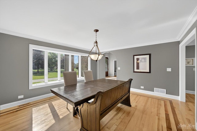 1714 Il Route 173, Spring Grove, IL 60081 - dining area featuring arched walkways, ornamental molding, light wood-style floors, and baseboards